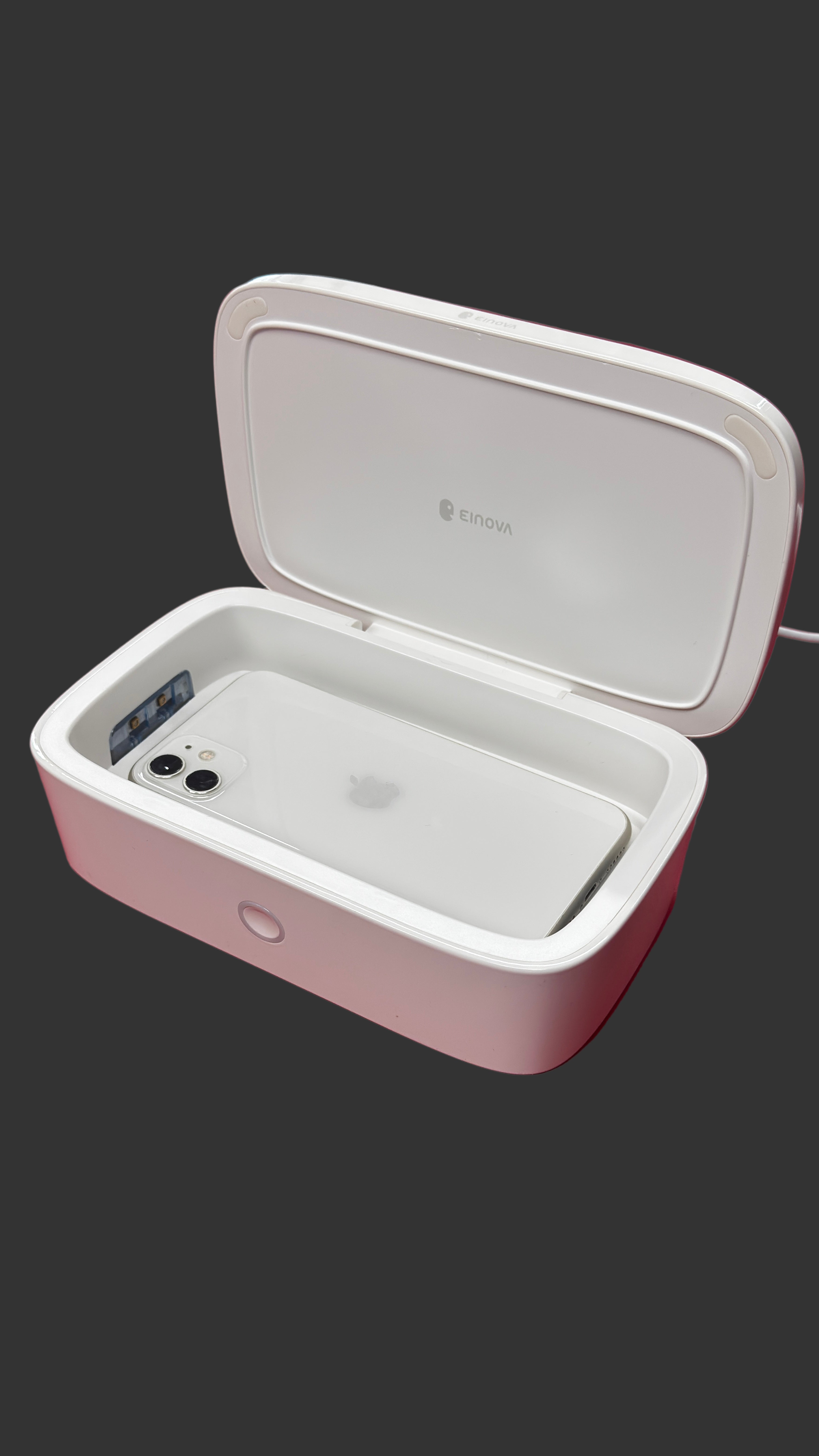 White phone in a protective case on a surface with a blurred background