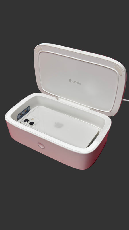 White phone in a protective case on a surface with a blurred background