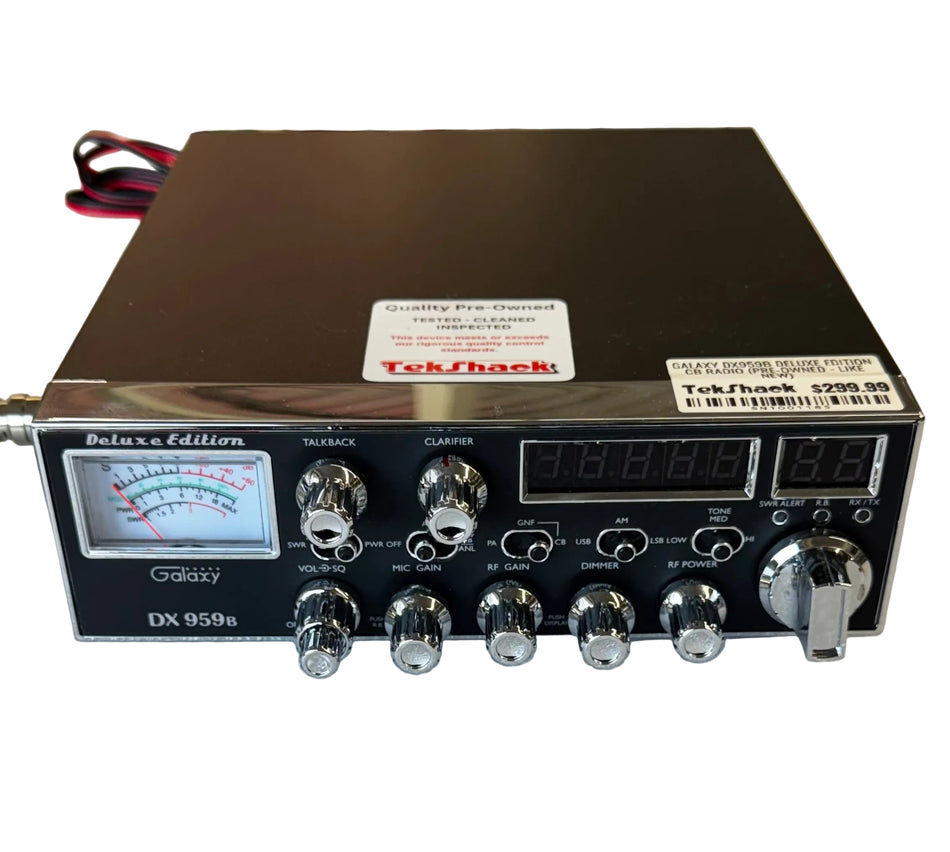 Radio communication device with digital display and control knobs on a white surface.