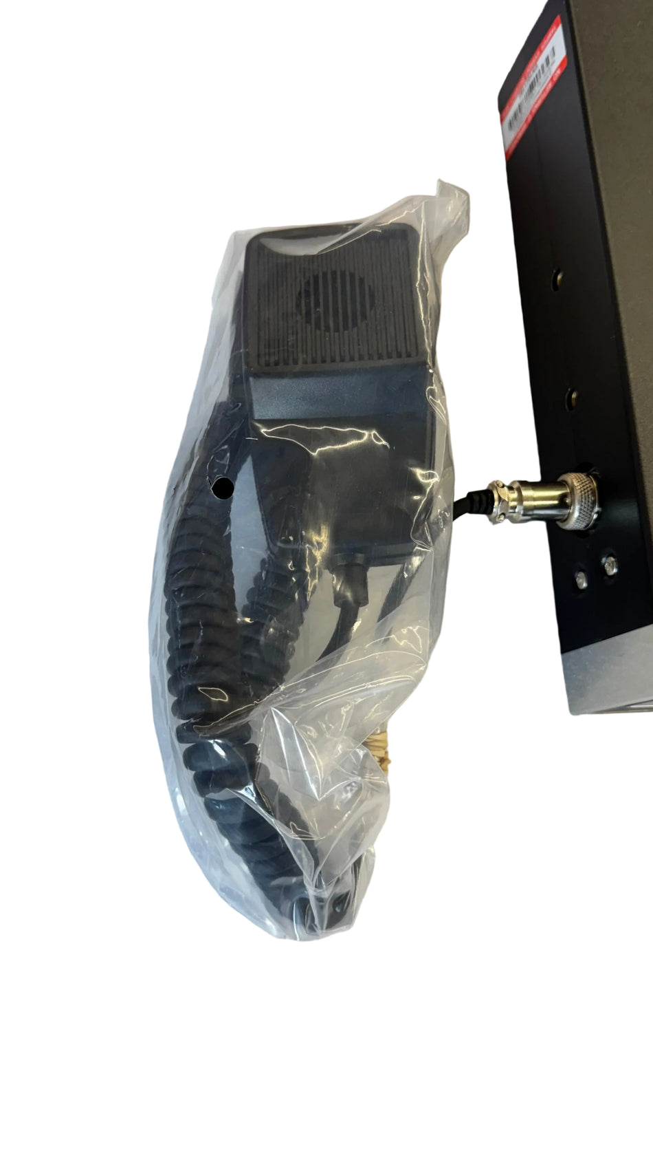 Black electronic device with a cord on a white surface